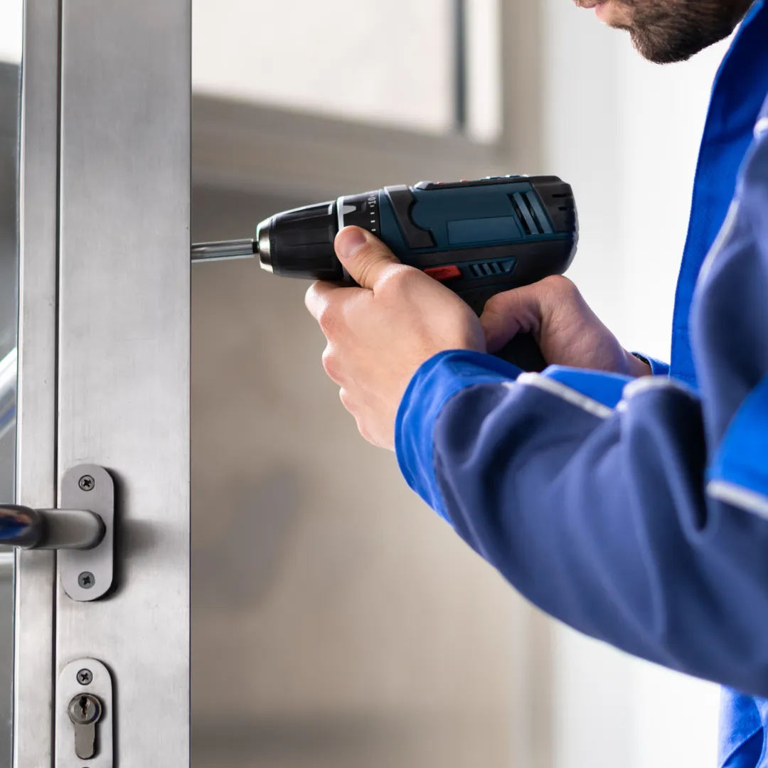 Locksmith using a key cutting machine to make new keys for a Port Saint Lucie home