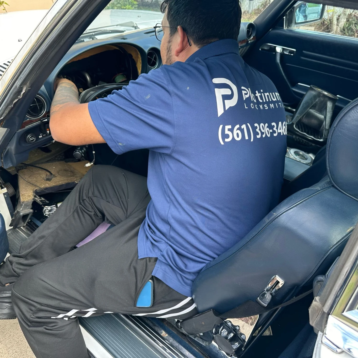 Locksmith Moab working inside a classic vehicle on the ignition lock, automotive locksmith Port St. Lucie