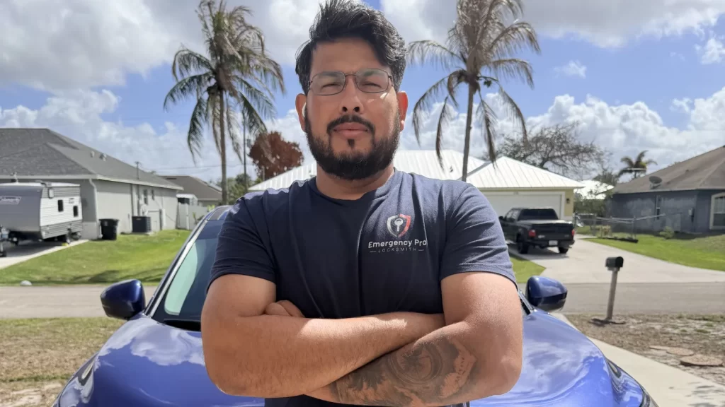 Moab, the licensed locksmith and owner of Emergency Pro Locksmith, smiling in front of his branded service van in Florida