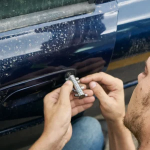 Locksmith using a decoder tool on a blue car door lock, emergency car locksmith Port St. Lucie
