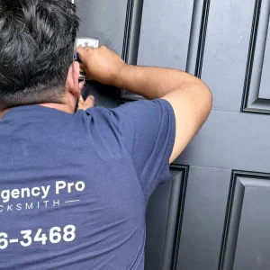 Emergency Pro Locksmith technician in branded uniform standing beside a customer's car after service in Port St. Lucie, Florida